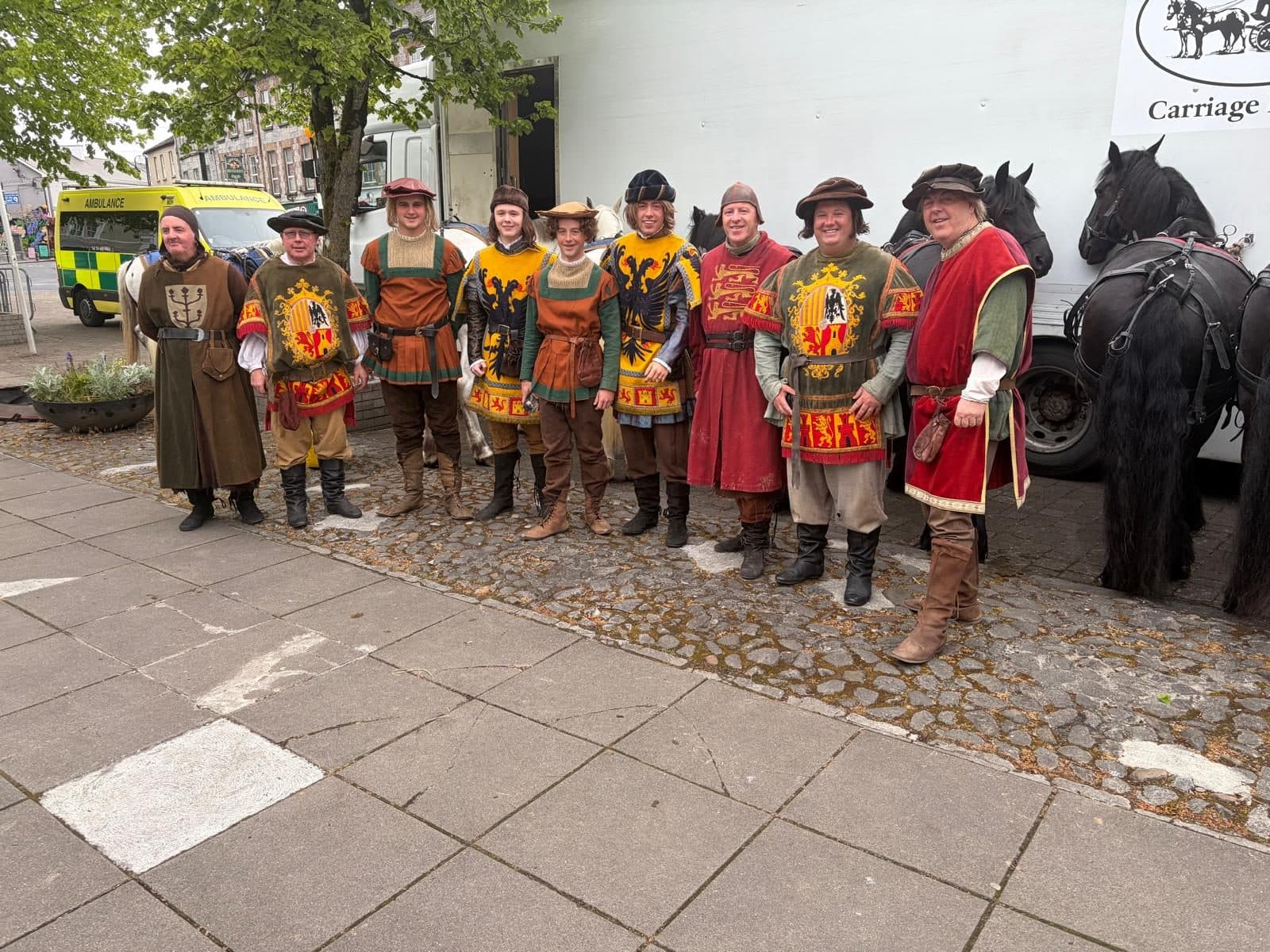 A full costumed cast lined up with the Mulreanys horses and transport truck