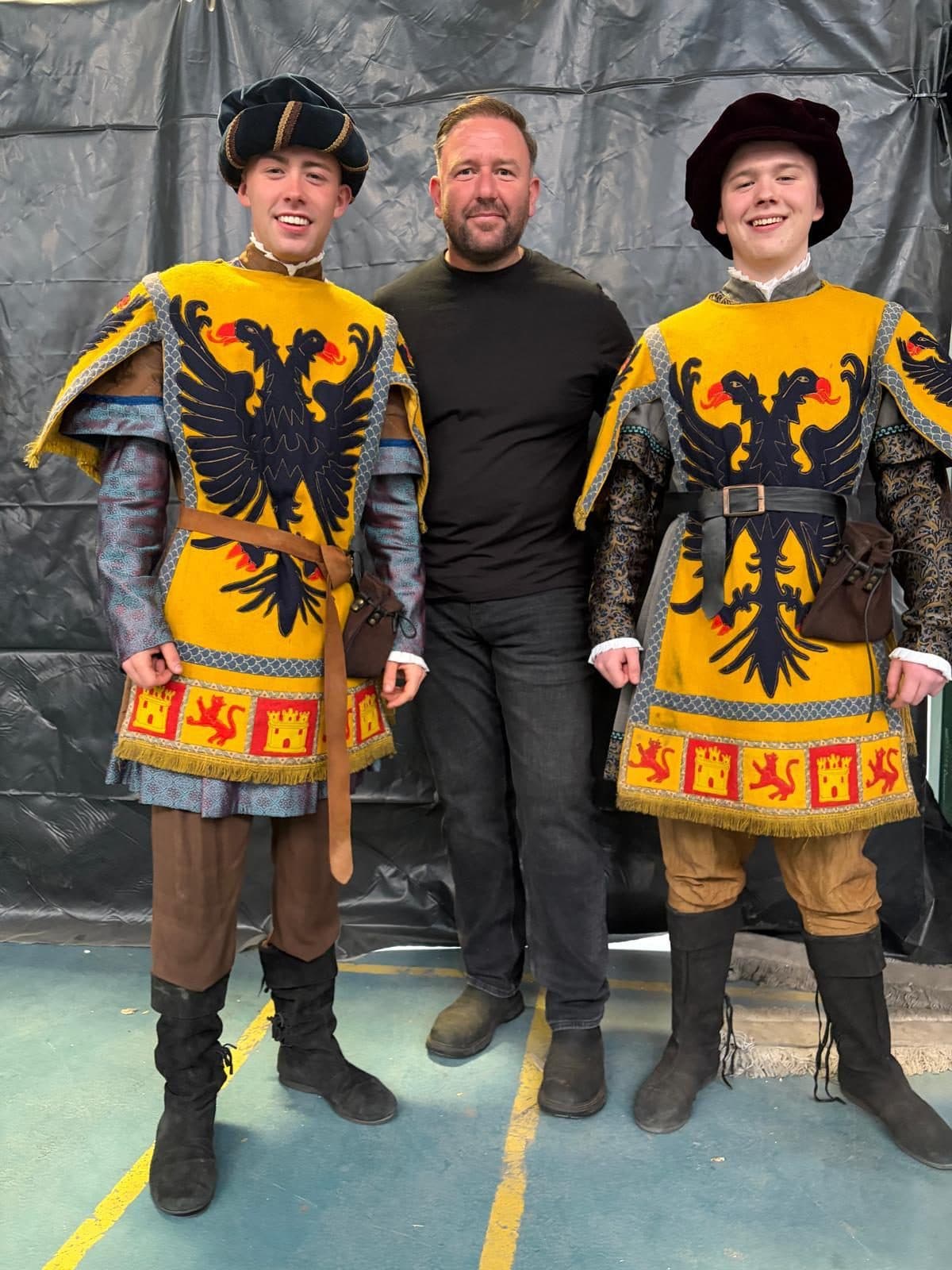 David Mulreany with two costumed riders in heraldic livery on set